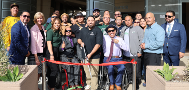 Group of People Cutting a Ribbon